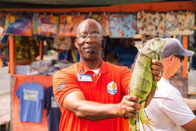 Guide holding an iguana