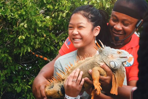 Girl holding a big iguana